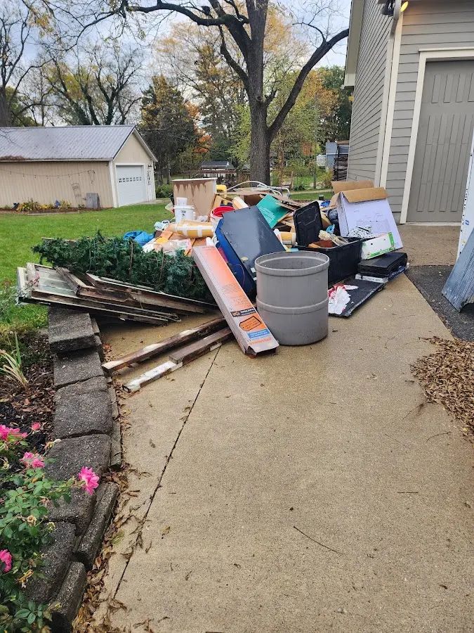 Dumpster being loaded with debris for Roofing Dumpster Rental in Kinston